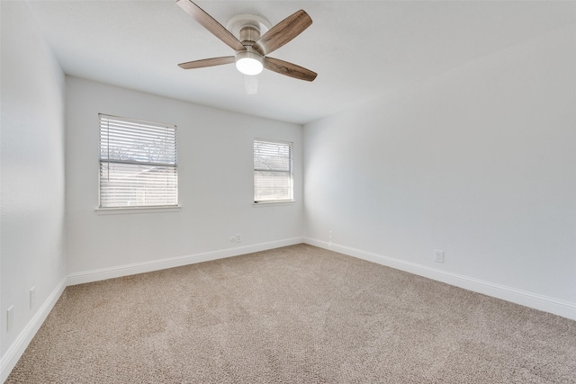 empty room featuring ceiling fan and carpet