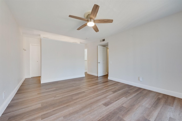 empty room with light wood-type flooring and ceiling fan