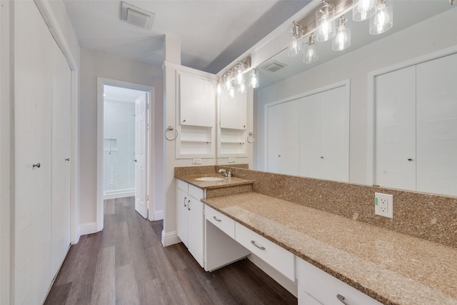 bathroom with hardwood / wood-style floors and vanity