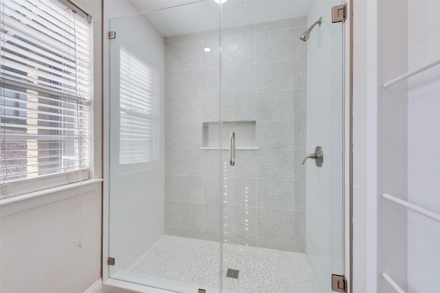 bathroom with a shower with door