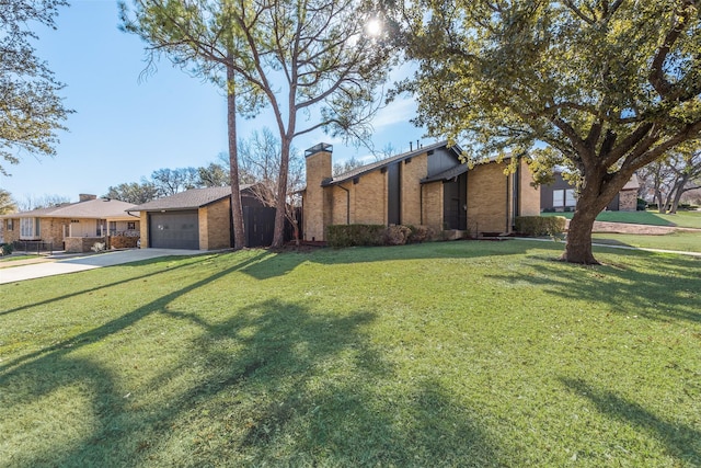 view of front of house with a garage and a front lawn