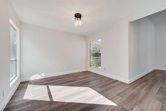 empty room with dark hardwood / wood-style flooring