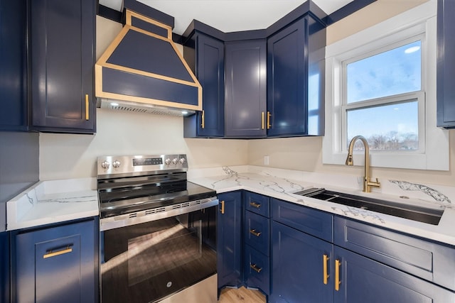 kitchen featuring sink, custom exhaust hood, blue cabinetry, and stainless steel electric range