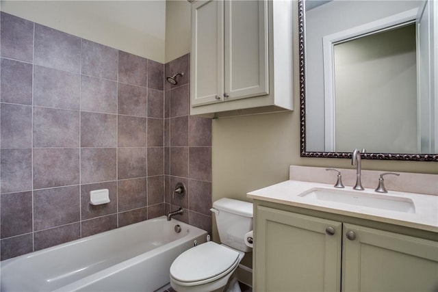 full bathroom featuring toilet, vanity, and tiled shower / bath