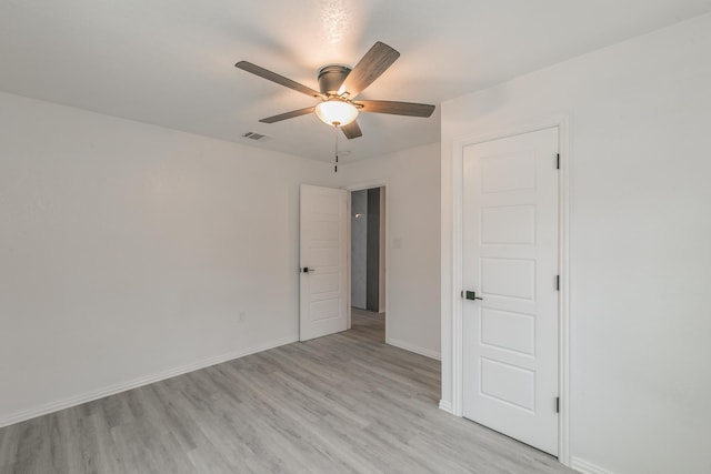 empty room featuring ceiling fan and light hardwood / wood-style flooring