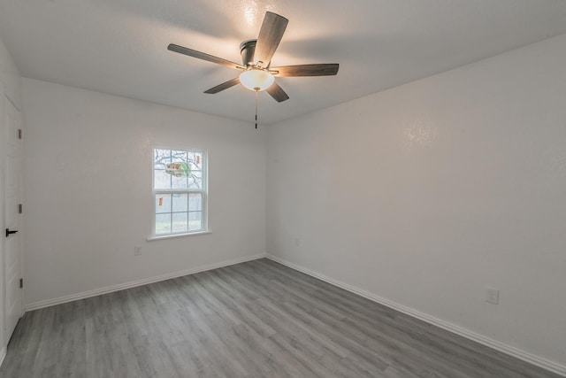 spare room with wood-type flooring and ceiling fan