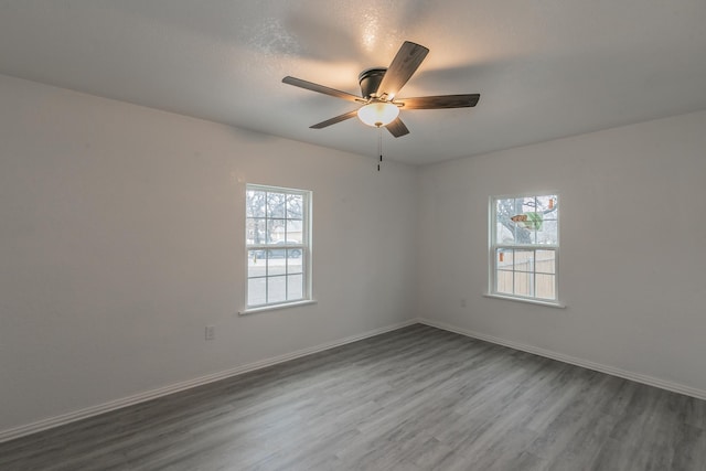 spare room with hardwood / wood-style flooring and ceiling fan