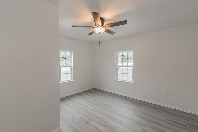 unfurnished room featuring hardwood / wood-style flooring and ceiling fan