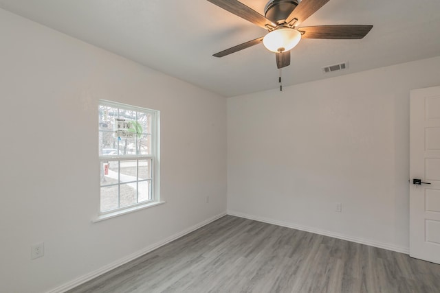 spare room featuring hardwood / wood-style flooring and ceiling fan