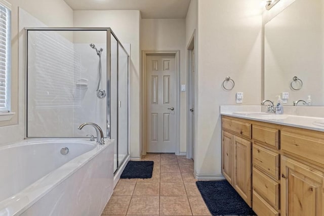 bathroom with vanity, tile patterned floors, and shower with separate bathtub