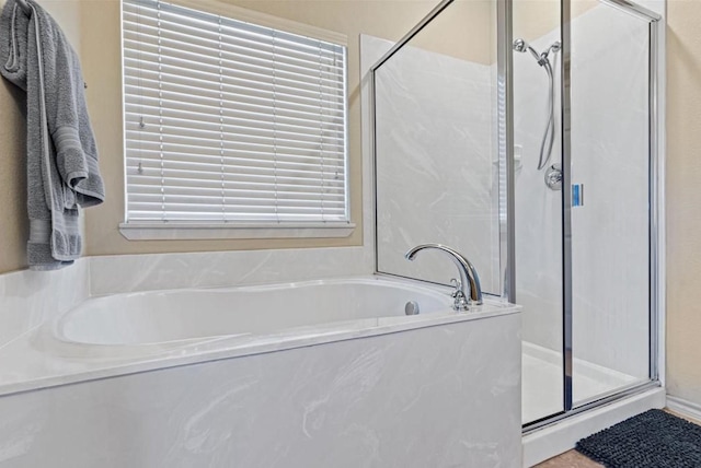 bathroom featuring separate shower and tub