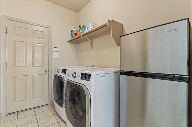 laundry room with light tile patterned floors and washer and dryer