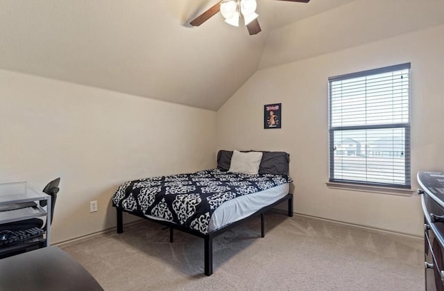 carpeted bedroom featuring vaulted ceiling and ceiling fan