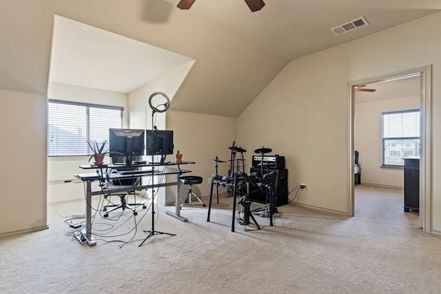 office space with vaulted ceiling, ceiling fan, and light carpet