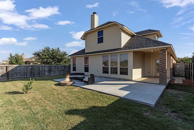 rear view of property with an outdoor fire pit, a yard, and a patio