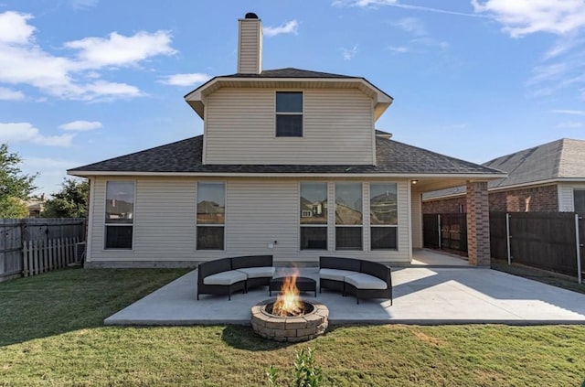 rear view of house featuring a yard, a fire pit, and a patio