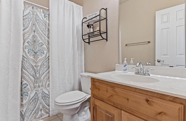 bathroom with toilet, tile patterned floors, and vanity