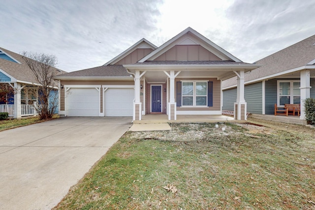 view of front of house featuring a garage, a front yard, and a porch