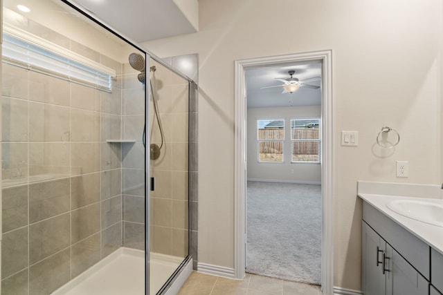 bathroom with a shower with shower door, tile patterned floors, and vanity