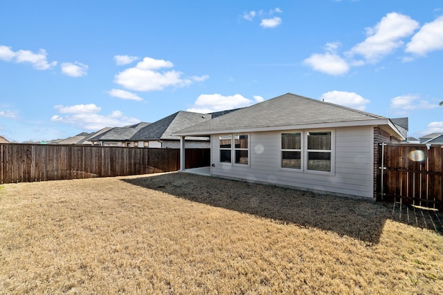 rear view of house with a yard