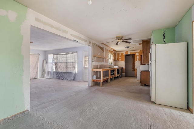 unfurnished living room featuring ceiling fan