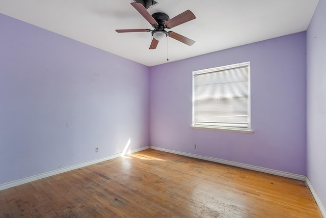 spare room featuring light wood-type flooring and ceiling fan