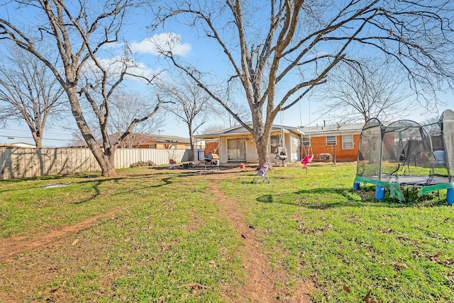 view of yard featuring a patio and a trampoline