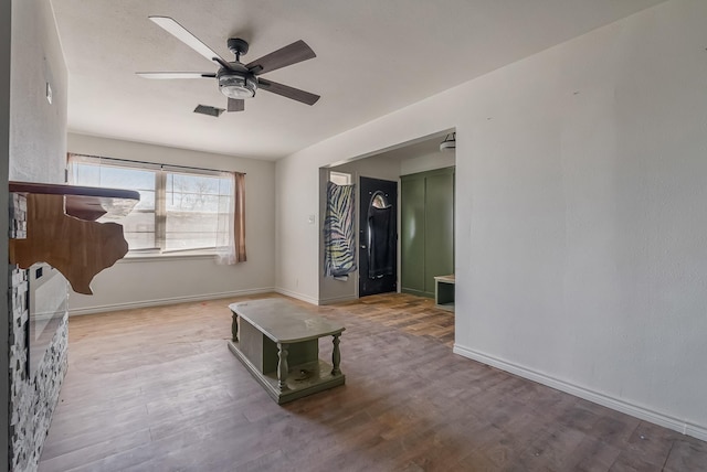 interior space with ceiling fan and hardwood / wood-style floors