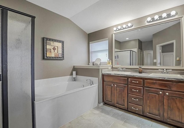 bathroom featuring plus walk in shower, lofted ceiling, and vanity