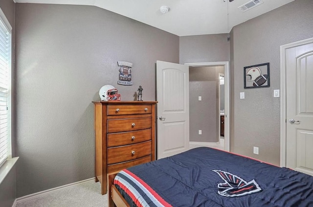 carpeted bedroom featuring lofted ceiling