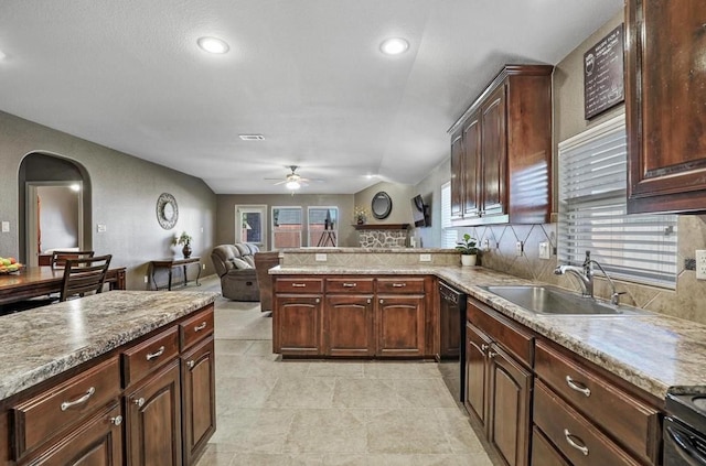 kitchen with black dishwasher, sink, dark brown cabinetry, kitchen peninsula, and ceiling fan