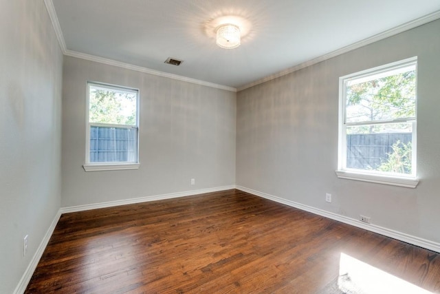 empty room featuring ornamental molding and dark wood-type flooring