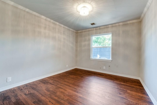 empty room featuring dark hardwood / wood-style flooring and crown molding