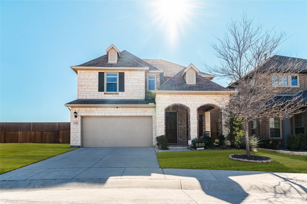 view of front of house with a garage and a front yard