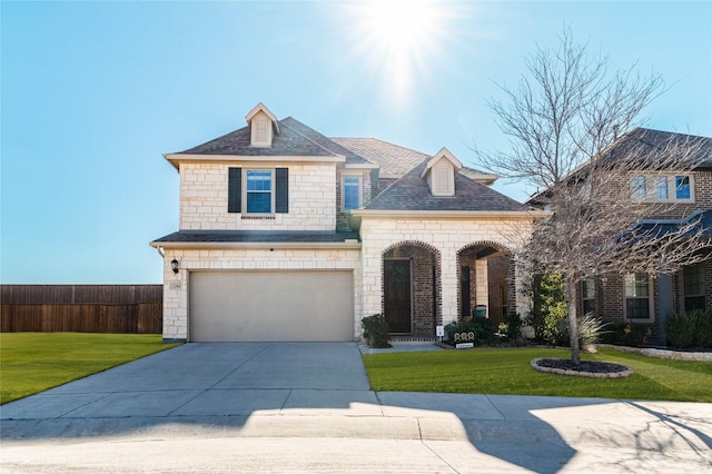 view of front of house with a garage and a front yard