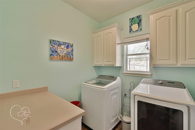 laundry area featuring separate washer and dryer and cabinets