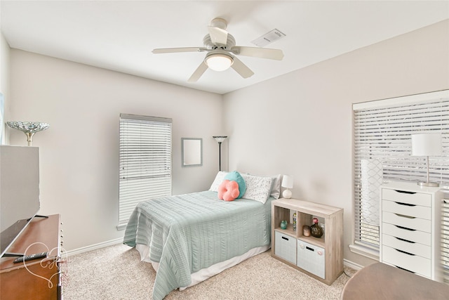 bedroom with ceiling fan and light carpet