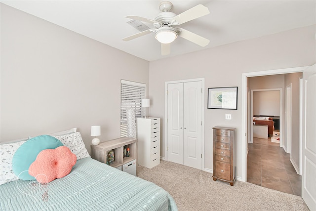 carpeted bedroom featuring a closet and ceiling fan