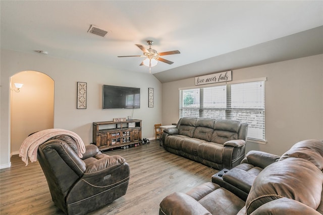 living room featuring ceiling fan, lofted ceiling, and light wood-type flooring