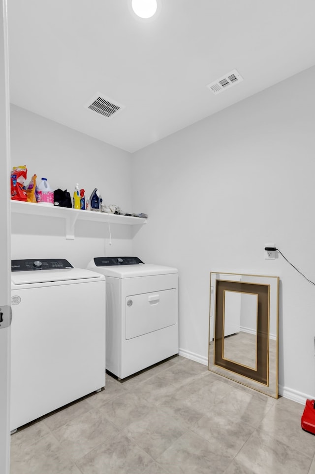 laundry room featuring washer and clothes dryer