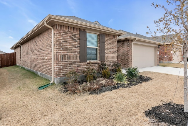 view of home's exterior featuring a garage and a yard