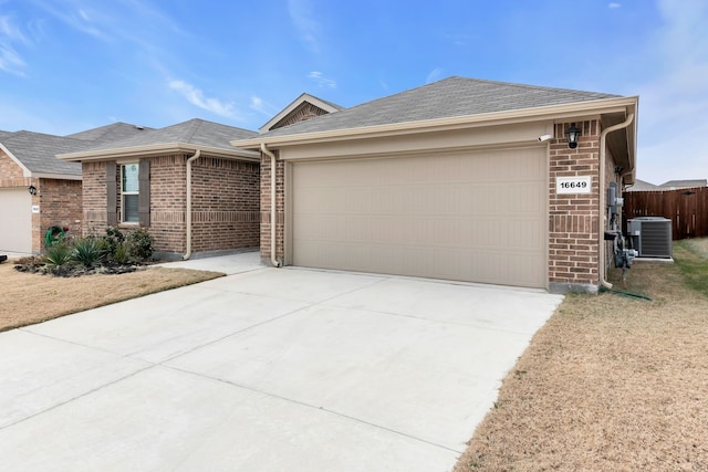 single story home with a garage and central air condition unit