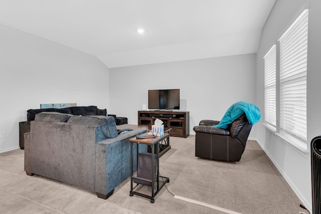 carpeted living room featuring vaulted ceiling