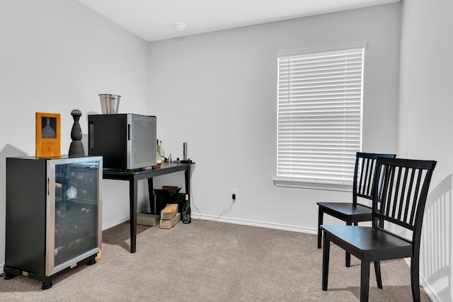 office area with light carpet and beverage cooler