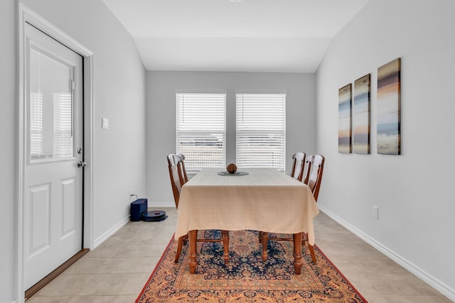 tiled dining area with lofted ceiling