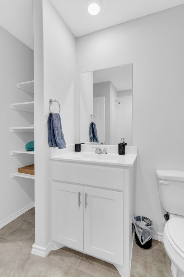 bathroom featuring walk in shower, tile patterned floors, toilet, and vanity