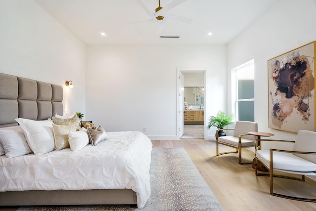 bedroom with ceiling fan, light hardwood / wood-style floors, and ensuite bath