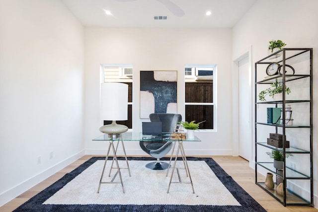 office space with light hardwood / wood-style floors and ceiling fan