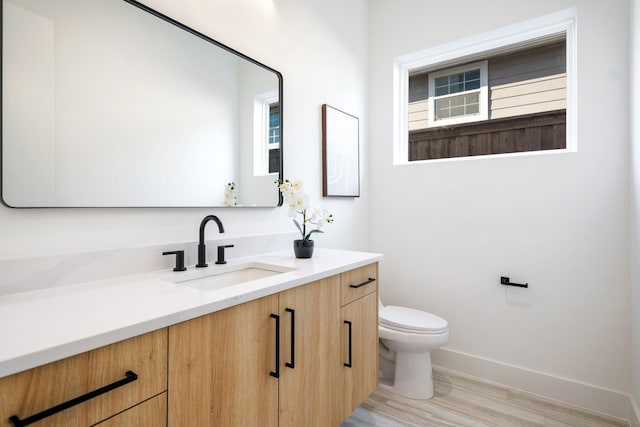 bathroom featuring hardwood / wood-style floors, toilet, and vanity