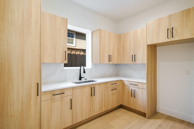 kitchen featuring sink, light brown cabinets, and light hardwood / wood-style floors